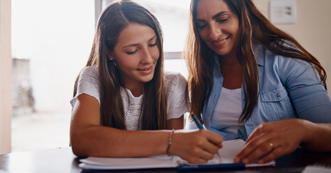 Homeschool mother and daughter learning Essentials and Latin