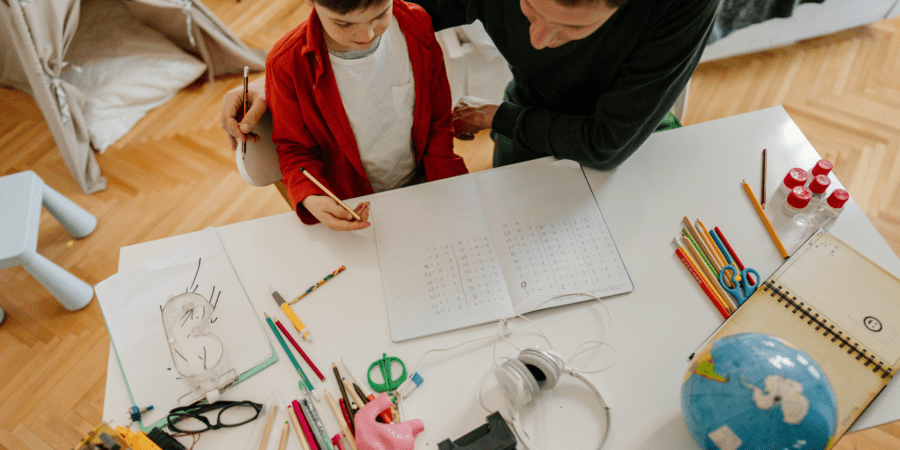 A father homeschooling his son.