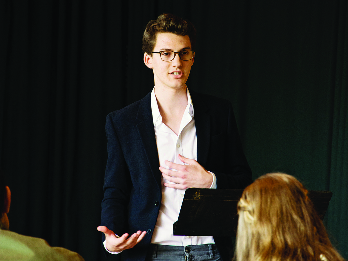 Young man speaking to a group
