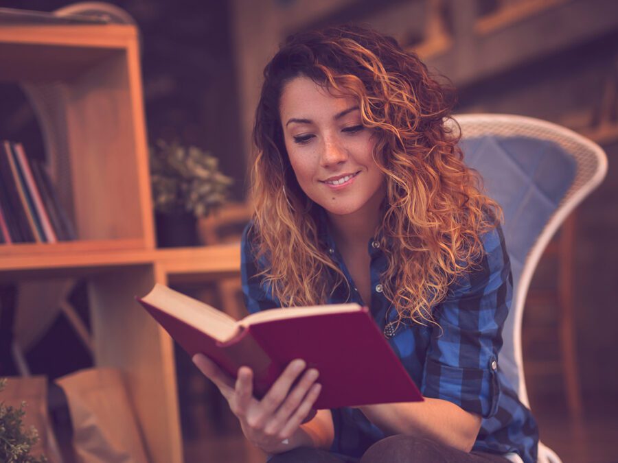 a women reads an old book in a library