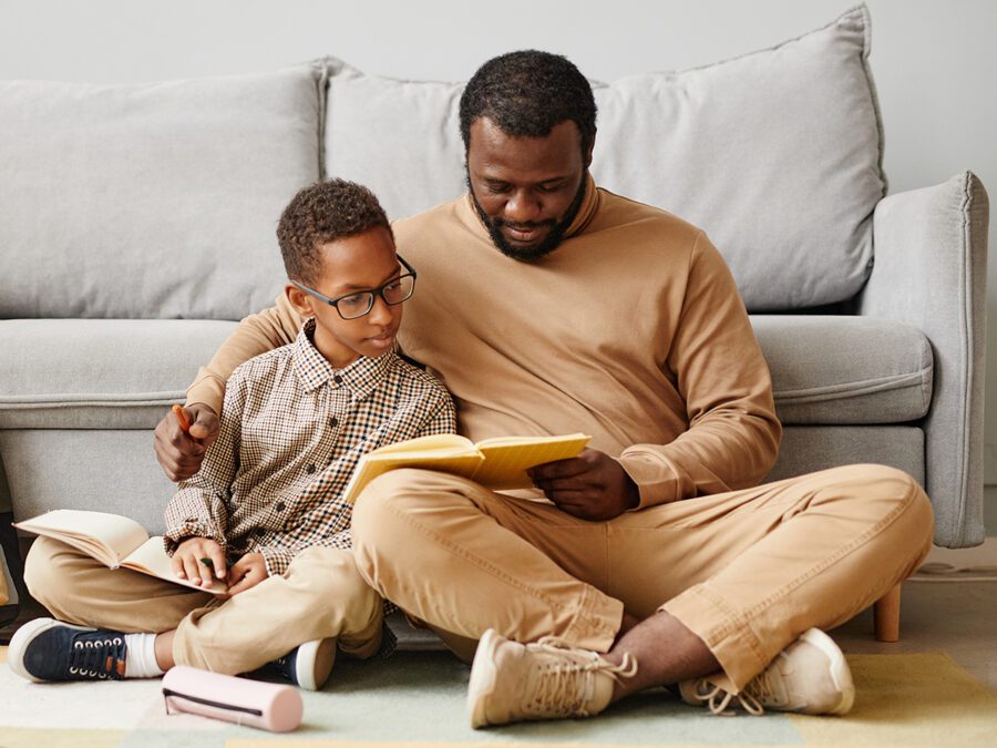 A father and son read together. The best homeschool curriculum involves reading - lots of reading!