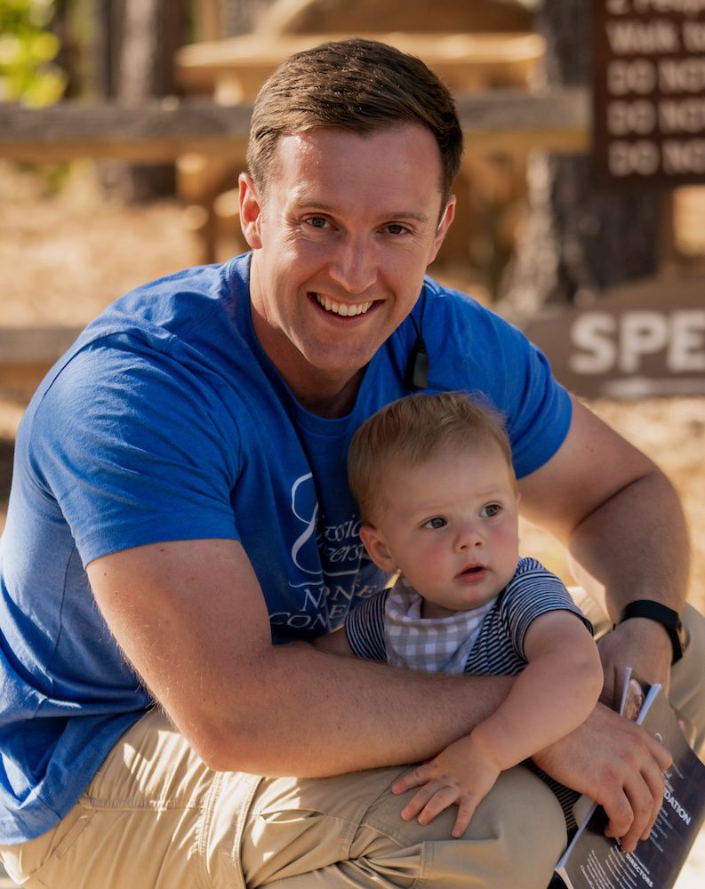 a homeschool dad holding his baby