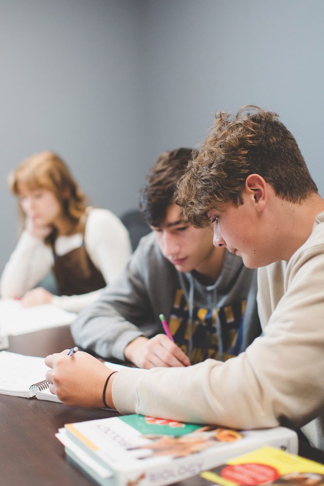 two students working through a notebook
