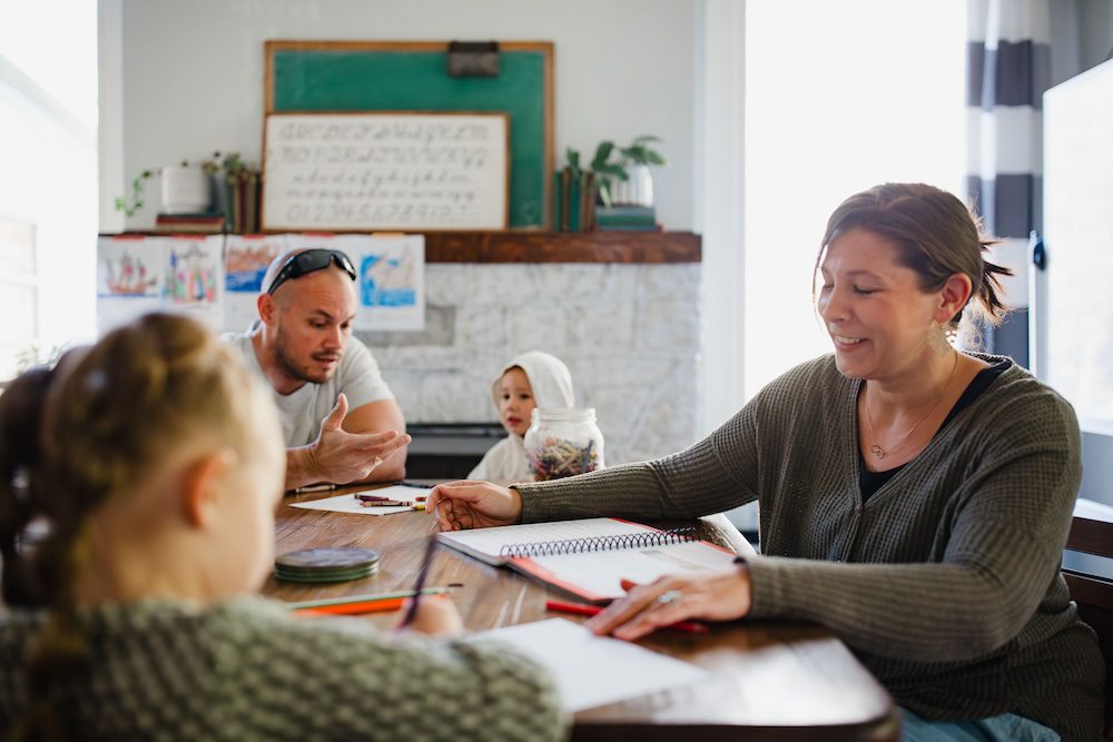 a homeschool family learning around the table