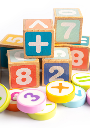 wooden blocks painted with numbers and math symbols