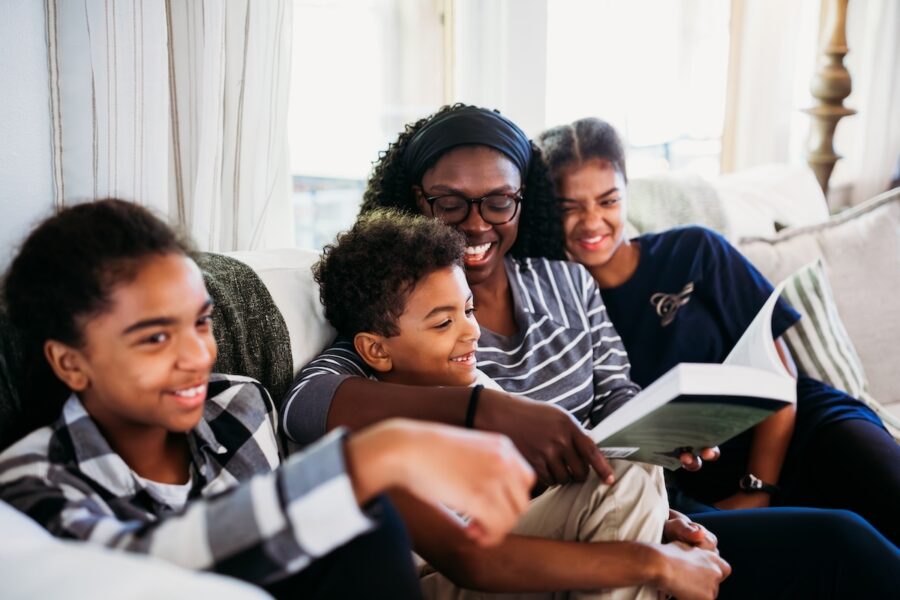 A homeschool mom reading to her children