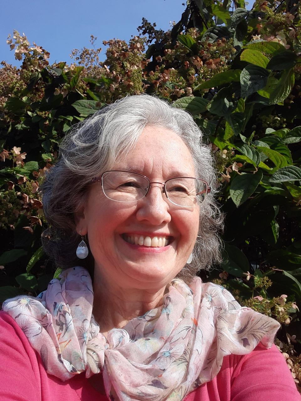 headshot of woman in pink shirt: Amy Jones