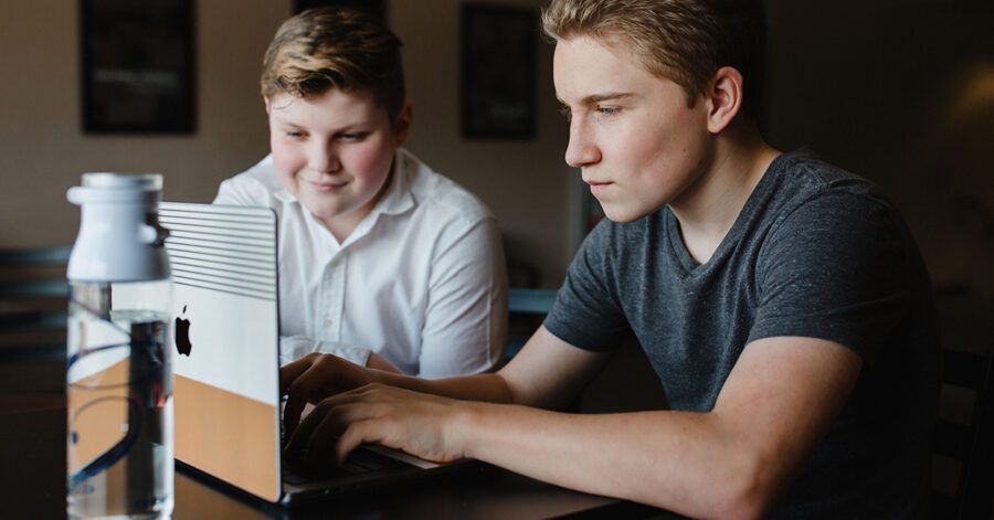 Two older homeschool boys researching on a computer