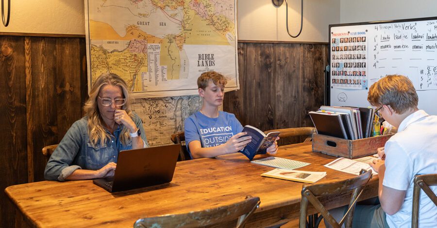 Homeschool family at a table doing schoolwork